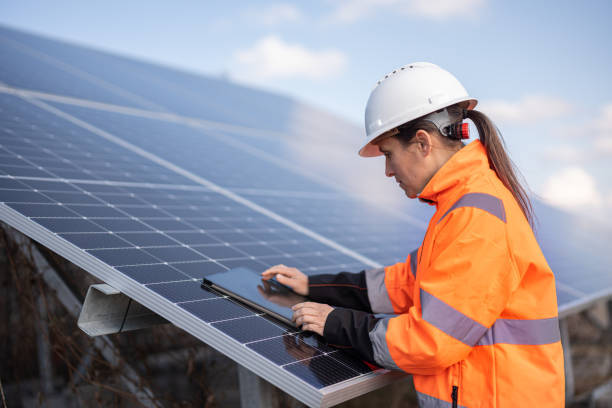 Woman electrician working in solar energy storing solutions.