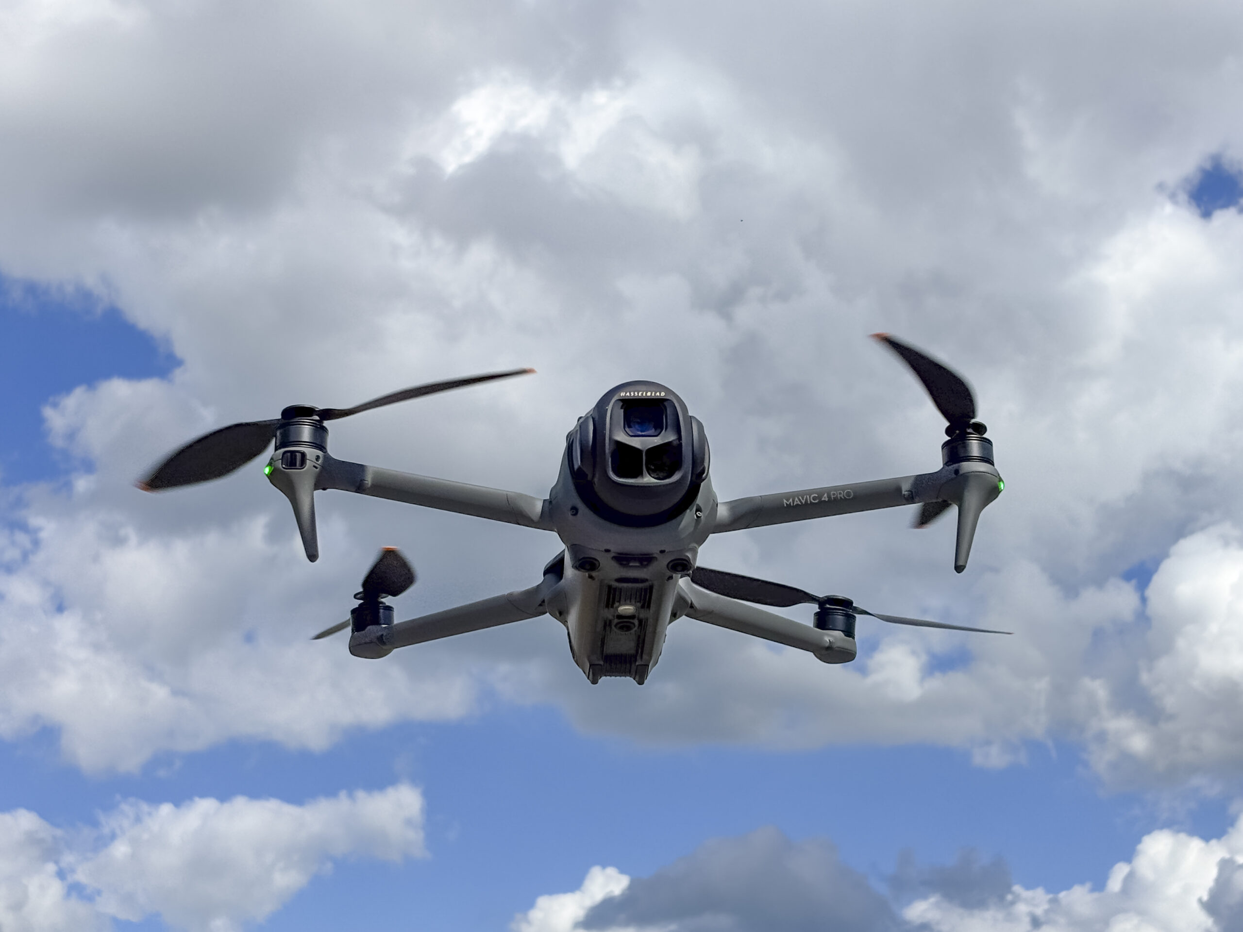 DJI Mavic 4 Pro drone flying in the air with the Hasselblad gimbal camera pointing forward. The Mavic 3 is a teleoperated quadcopter drone for aerial photography and videography mad by Chinese manufacturer DJI.